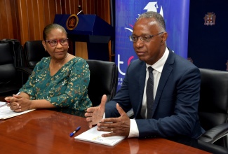 Deputy Chief Education Officer, Planning and Development Division, Ministry of Education, Skills, Youth and Information, Vivienne Johnson, listens to remarks from President of George Brown College in Ontario, Canada, Dr. Gervan Fearon (right), during a courtesy call on Friday (July 11) at the Ministry in Kingston.