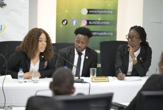 Captain for the Ministry of Tourism debate team, Matthew Blake (centre), flanked by team members during the recent semi-finals of the Public Sector Debate Competiton.

