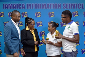 Executive Director, Social Development Commission (SDC), Omar Frith (left) and Director, Local Economic Development at SDC, Avril Ranger (second left), in conversation with Owner, Nikki's Spices and more, Rosemarie Johnson, and Chief Executive Officer (CEO) and Founder of Paradise Blends, Romeo Mitchell (right), following a recent Jamaica Information Service Think Tank in Kingston. Ms. Johnson and Mr. Mitchell represent two of the 390 Local Economic Initiatives (LEIs) being served by the SDC.