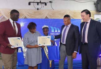 Regional Director of Region Six in the Ministry of Education, Skills, Youth and Information, Sophia Forbes-Hall (second left), congratulates winner of the National Water Commission (NWC)/Miya Water Jamaica Limited Schools TikTok Water Conservation Challenge, Kamea Campbell (centre), at the NWC/Miya Non-Revenue Water (NRW) Staff Recognition Ceremony, held on Thursday (July 24), at the Power of Faith Ministries International Multipurpose Complex in Portmore, St. Catherine. At left is Tajay Bell, who placed second. Also sharing the moment are Acting President of the NWC, Kevin Kerr (second right), and Chief Executive Officer (CEO) of Miya, José Carazo.