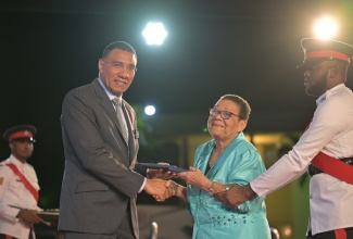 Prime Minister, Dr. the Most Hon. Andrew Holness, presents retired Educator, Elaine Carlene Elliott-Matthews, with the Prime Minister’s Medal of Appreciation for Service to Education, at the recent awards ceremony held on the lawns of Jamaica House. 

