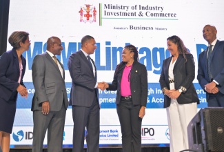 Prime Minister, Dr. the Most Hon. Andrew Holness (third left) congratulates Founder and Chief Executive Officer, STEM Builders Learning Hub, and winner of the MSME Masters Business Pitch Competition, Kavelle Hylton (third right), during the MSME linkages day event at the University of Technology on July 15. Sharing in the moment (from left) are: Permanent Secretary in the Ministry, Sancia Bennett Templer; Minister of Industry, Investment and Commerce, Senator Hon. Aubyn Hill; Chief of Operations for the Caribbean Region, Inter-American Development Bank, Karisa Ribeiro; Managing Director, Development Bank of Jamaica, Dr. David Lowe.