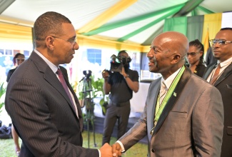 Prime Minister, Dr. the Most Hon. Andrew Holness (left), congratulates the newly installed Custos Rotulorum of Hanover, the Hon. Lennox Anderson-Jackson, during the official installation ceremony held at Rusea