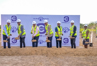 Prime Minister, Dr. the Most Hon. Andrew Holness (fourth left), breaks ground for the Caymanas Special Economic Zone (CSEZ) project in St. Catherine on Tuesday (July 29). Also participating are (from left) Port Authority of Jamaica (PAJ) President and Chief Executive Officer, Professor Gordon Shirley; Factories Corporation of Jamaica (FCJ) Chairman, Lyttleton Shirley; Opposition Spokesperson on Industry, Investment and Global Logistics, Anthony Hylton; Minister of Industry, Investment and Commerce, Senator the Hon. Aubyn Hill; PAJ Chairman, Alok Jain; and PAJ Vice President of Business Process Outsourcing and Logistics, Gloria Henry, and Senior Vice President of Engineering and Port Development, Gary Lawrence.