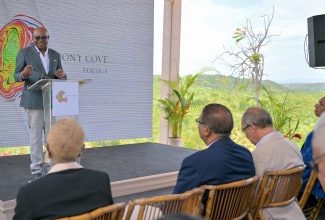 Minister of Tourism, Hon. Edmund Bartlett, addresses the ribbon-cutting ceremony for the Harmony Cove development project in Duncans, Trelawny, on July 22.

