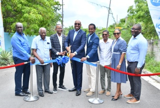 State Minister in the Ministry of Tourism, Senator the Hon. Delano Seiveright (fourth left), cuts the ribbon to officially open phase one of the newly rehabilitated West End Road in Negril, Westmoreland, on Thursday (July 17). Joining him are (from left) Councillor of the Negril Division, Arthel Colley; Tourism Enhancement Fund (TEF) Chairman, Godfrey Dyer; Member of Parliament for Westmoreland Western, Moreland Wilson; TEF Executive Director, Dr. Carey Wallace; Negril Destination Assurance Council Chairman, Richard Wallace; Jamaica Tourist Board (JTB) Regional Manager, Odette Dyer, and Tourist Product Development Company (TPDCo) Executive Director, Wade Mars.