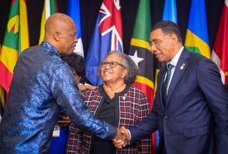 Caribbean Community CARICOM Chair, Prime Minister, Dr. the Most Hon. Andrew Holness (right), greets University of the West (UWI) Vice Chancellor, Sir Hilary Beckles, during the opening plenary session of the 49th Regular Meeting of the Conference of Heads of Government of CARICOM at the Montego Bay Convention Centre on Monday (July 7). Looking on is CARICOM General Secretary, Dr. Carla Barnett. The Conference is being held from July 6 to 8 under the theme ‘People, Partnerships, Prosperity: Promoting A Secure and Sustainable Future’.

