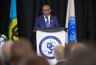 Newly installed President of the Caribbean Court of Justice (CCJ), Hon. Mr. Justice Winston Anderson, delivers his inaugural address during the Swearing-In Ceremony at the Jewel Grande Resort in Montego Bay, St. James, on Sunday (July 6). 

