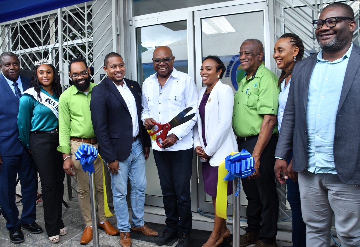 Tourism Minister, Hon. Edmund Bartlett (centre), cuts the ribbon to officially open the Tourism Product Development Company (TPDCo) office in Black River, St. Elizabeth, on Wednesday (July 16). Joining Mr. Bartlett are (from left) Assistant Commissioner of Police, Dr. Gary McKenzie; Miss St. Elizabeth Festival Queen 2025, Samantha Barnett; Mayor of Black River, Councillor Richard Solomon; Minister of Agriculture, Fisheries and Mining and Member of Parliament for St. Elizabeth South Western, Hon. Floyd Green; General Manager of the Milk River Hotel and Spa, Diane Somerville; State Minister in the Agriculture Ministry and Member of Parliament for St. Elizabeth South Eastern, Hon. Franklin Witter; President of the St. Elizabeth Chamber of Commerce, Kadian Myers Brown, and Executive Director of the TPDCo, Wade Mars.