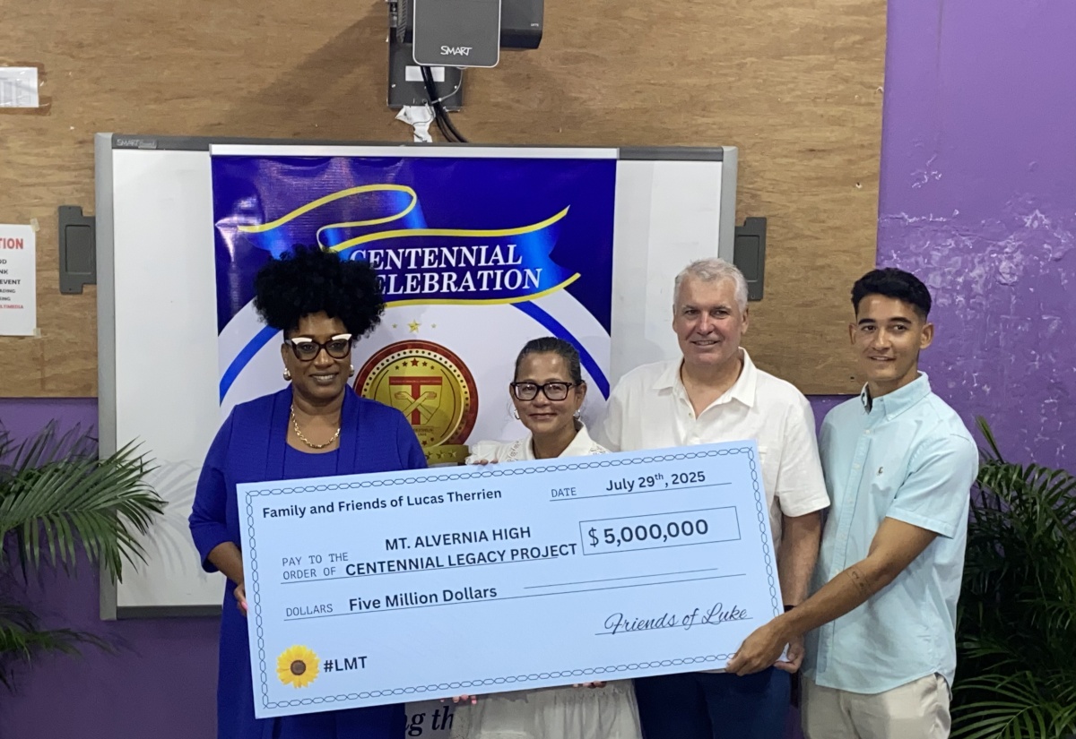 Principal of Mount Alvernia High School in Montego Bay, Kayon Whyne (left), receives a $5 million donation from Anne Chang, mother of the late Luke Therrien;  his father, Ray Therrien; and brother Jake Therrien, representing the Friends of Luke. The handover ceremony was held at the institution in Montego Bay, St. James on Tuesday (July 29). The funds will go towards refurbishing the school’s multi-purpose auditorium.