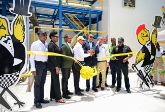Prime Minister, Dr. the Most Hon. Andrew Holness (centre), and Chairman of the Jamaica Broilers Group, Robert Levy (fourth left), cut the ribbon to officially commission a US$8-million Liquified Natural Gas (LNG) Cogeneration Plant at Best Dressed Chicken in Spring Village, St. Catherine, on Tuesday (August 5). They are joined by (from left) Vice President, Best Dressed Chicken Division, Jamaica Broilers, Dave Fairman; Scotia Group President and Chief Executive Officer, Audrey Tugwell Henry; Minister of Agriculture, Fisheries and Mining, Hon. Floyd Green; Minister of Science, Energy, Telecommunications and Transport, Hon. Daryl Vaz; Jamaica Broilers Group President and Chief Executive Officer, Christopher Levy; Minister of State in the Ministry of Agriculture, Fisheries and Mining, Hon. Franklin Witter; and Minister of Industry, Investment and Commerce, Senator the Hon. Aubyn Hill.