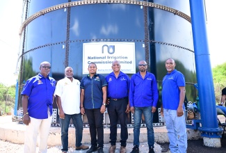 Minister of Agriculture, Fisheries and Mining, Hon. Floyd Green (third left), and State Minister in the Agriculture Ministry, Hon. Franklin Witter (third right), share lens time with stakeholders and Ministry representatives during the commissioning ceremony for a 130,000-gallon sectional water tank in New Forest, Manchester, on August 15. From left are National Irrigation Commission Limited (NIC) Regional Systems Manager for Clarendon and Manchester, Fitzgerald Reid; Permanent Secretary in the Agriculture Ministry, Dermon Spence; and NIC Chief Executive Officer, Joseph Gyles, and Director of Engineering and Technical Services, Rohan Stewart.