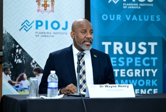 Director General, Planning Institute of Jamaica (PIOJ), Dr. Wayne Henry, addresses Tuesday’s (August 19), hybrid Quarterly Press Briefing at the PIOJ’s Oxford Road offices in Kingston.