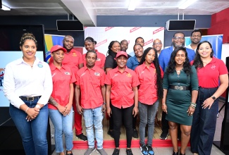 Tourism Product Development Company Limited (TPDCo) Executive Director, Wade Mars (second row, right), shares lens with trainee bartenders who will benefit from the Port Royal Saloon Waters Tour following the signing of a Memorandum of Understanding between TPDCo and Red Stripe on Monday (August 25). The MOU represents an agreement between the two entities to collaborate on the development of the Port Royal Saloon Waters Tour. They are joined by Brand Manager of Red Stripe and Dragon Stout, Amoye Phillpotts-Brown (front row, right); TPDCo Destination Manager for Kingston, Mikisha Silvera (front row, second right); and TPDCo Director of Product Development and Community Tourism, Kerry-Ann Lowe (front row, left). The signing of the MOU took place at Red Stripe’s Spanish Town Road headquarters in Kingston.