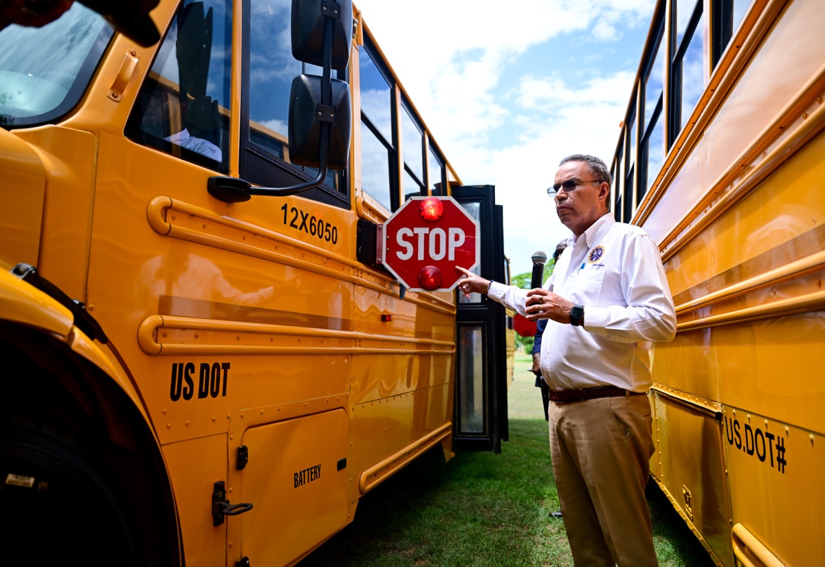 Minister of Science, Energy, Telecommunications and Transport, Hon. Daryl Vaz, inspects a school bus during the Blessing Ceremony for the National Rural School Bus Programme, held Wednesday (August 27) at Jamaica House.

