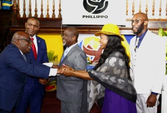 Permanent Secretary in the Ministry of Education, Skills, Youth, and Information, Dr. Kasan Troupe (second right), is greeted by former President of the Jamaica Teachers’ Association (JTA), Leighton Johnson (left), at yesterday’s (August 17) Jamaica Teachers’ Association (JTA) Annual Church Service, held at the Phillippo Baptist Church in Spanish Town, St. Catherine. Others pictured (from left) are President of the Association, Dr. Mark Smith; Pastor of the church, the Reverend Karl Johnson, and President-Elect of the JTA, Mark Malabver.