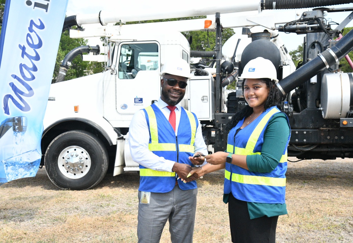 Advisor to the Minister without Portfolio in the Ministry of Economic Growth and Job Creation, Nicole Ebanks, hands over the keys to two Vactor jet trucks to Acting Vice President of Operations, National Water Commission (NWC), Herman Fagan, at the NWC’s Marescaux Road location in Kingston on Thursday (August 14). The units will be utilised in clearing blockages and cleaning sewer lines to keep stormwater systems flowing smoothly.

