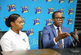 Chief Executive Officer at the Toll Authority of Jamaica, Jerome Palmer (right), addresses a JIS Think Tank on August 19, on recent upgrades implemented by Jamaica North South Highway Company Ltd.  At left is Commercial and Marketing Manager at Jamaica North South Highway Company Ltd, Trudy-Ann Williams.