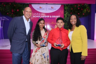 Guardian Group President for Life, Health and Pension, Eric Hosin, and Guardian Life Limited President, Meghon Miller-Brown, share a photo moment with 2025 Primary Exit Profile (PEP) National Top Girl, Rashmi Gibbore, and Top Boy, Miles Whittingham, during Guardian Life’s 19th Annual Scholarship Awards Ceremony, held recently at the Terra Nova All-Suite Hotel in Kingston.
