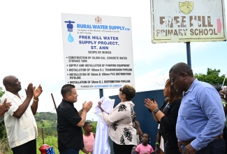 Minister without Portfolio in the Ministry of Economic Growth and Job Creation, Hon. Matthew Samuda (second from left), applaud the unveiling of the Free Hill Water Supply System signage at the official commissioning of the water infrastructure in St. Ann on Tuesday (July 29). He is joined by (l-r) Councillor for the Bamboo Division, Sydney Stewart; Member of Parliament, St. Ann North Western, Krystal Lee; Acting Managing Director of Rural Water Supply Limited (RWSL), Murie Bennett; and Regional Manager for the National Water Commission’s (NWC) North East region, Richard Williams.