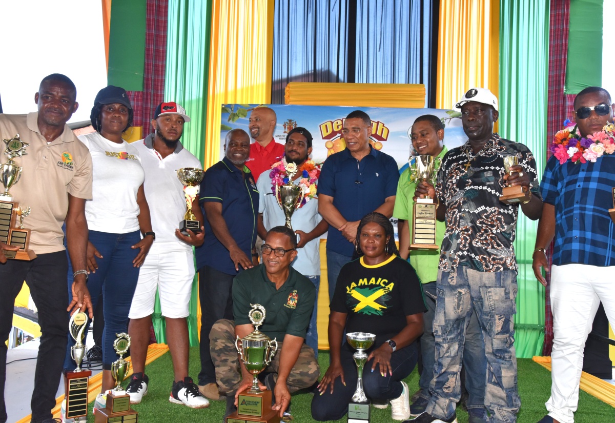 Prime Minister, Dr. the Most Hon. Andrew Holness (fourth right) and Agriculture, Fisheries and Mining Minister, Hon. Floyd Green (third right) with  the 2025 winners in the National Champion Farmers Competition, at the 71st Denbigh Agricultural, Industrial and Food Show closing ceremony, on Sunday, August 3. Also with the winners are Permanent Secretary in the Ministry, Dermon Spence (fourth left) and  Vice President of Hi-Pro, Colonel Jaimie Ogilvie (fifth left).

