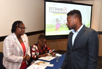 Medical Entomologist and National Programme Manager for Vector Control at the Ministry of Health and Wellness, Sherine Huntley-Jones (left), converses with  Senior Research Scientist at the International Centre for Environmental and Nuclear Sciences (ICENS) at the University of the West Indies (UWI) Mona Campus, Johann Antoine, at the Sterile Insect Technique (SIT) Pilot Project Workshop held on August 12 at the Jamaica Pegasus Hotel in New Kingston.