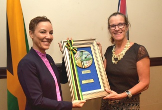 Minister of Foreign Affairs and Foreign Trade, Hon. Kamina Johnson Smith (left), presents a gift to outgoing British High Commissioner to Jamaica, Her Excellency Judith Slater, during a farewell luncheon hosted for the diplomat at The Jamaica Pegasus hotel in New Kingston on Friday (August 29).

 