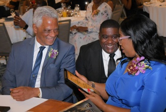 President of the Court of Appeal, Hon. Justice Marva McDonald-Bishop, congratulates Justice of the Peace (JP) and Kingston Chapter awardee, Dr. Mark Gonzales (centre), during the annual Lay Magistrates’ Association of Jamaica (LMAJ) Golden Scale Awards Banquet, held at the AC Hotel by Marriott Kingston on Saturday (August 23). Sharing the moment is LMAJ President Lyden Trevor Heaven. The Awards recognise outstanding JPs who ‘go the extra mile’ to provide exemplary voluntary service and leadership in their communities.
