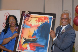 President of the Court of Appeal, Hon. Justice Marva McDonald-Bishop, receives a token from Lay Magistrates’ Association of Jamaica (LMAJ) President, Lyden Trevor Heaven, after delivering the keynote address during the LMAJ’s Annual Golden Scale Awards Banquet, held at the AC Hotel by Marriott Kingston on Saturday (August 23).

