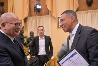 Prime Minister, Dr. the Most Hon. Andrew Holness (right), greets Project Manager, China Harbour Engineering Company (CHEC) Limited, Hongsheng Gui during a ceremony for the signing of a memorandum of understanding (MOU) between the Government and CHEC to conduct feasibility and impact studies for the proposed extension of the North-South Highway. The event took place on August 4 at Jamaica House.