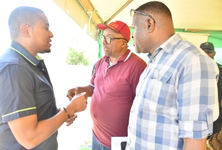 Minister of Agriculture, Fisheries and Mining, Hon. Floyd Green (left) speaks with Councillor of the Myersville Division, Layton Smith (centre) and Chief Executive Officer at the St. Elizabeth Municipal Corporation , Errol Lebert. Occasion was the reopening of the municipal corporation’s animal pound in Myersville in the parish on Friday (Aug. 15).