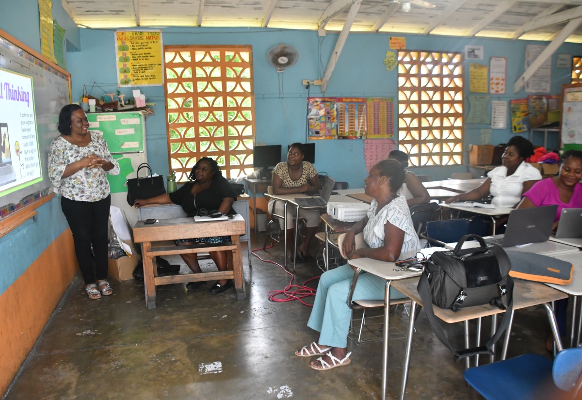Grade-four teacher at Broughton Primary School in Westmoreland, Errolyn Mullings-Williams (left), makes a presentation to fellow educators at the school during a teachers
