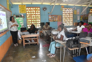 Grade-four teacher at Broughton Primary School in Westmoreland, Errolyn Mullings-Williams (left), makes a presentation to fellow educators at the school during a teachers' workshop on Thursday (August 28). 