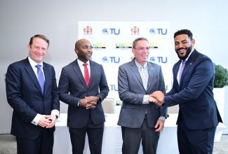 Minister of Transport, Telecommunications and Energy, Hon. Daryl Vaz (second right), shakes hands with Caribbean Telecommunications Union (CTU) President, Senator the Hon. Dominic Smith, during Monday’s (September 29) CTU ICT Week 2025 press briefing at the AC Hotel by Marriot Kingston. Others (from left) are: Chief Executive Officer, Internet Corporation for Assigned Names and Numbers (ICANN), Kurtis Lindqvist; and CTU Secretary General, Rodney Taylor.  


