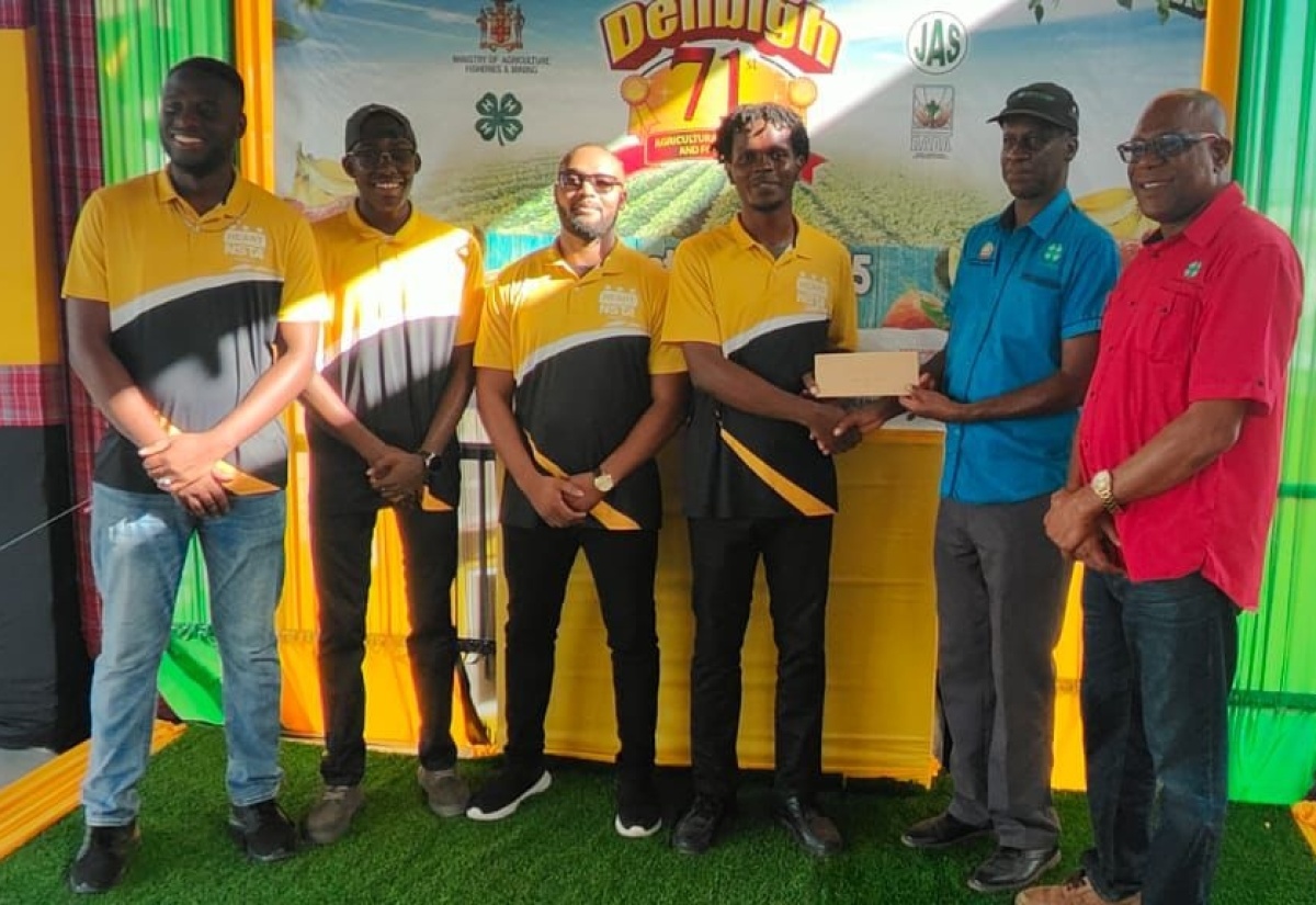 Developers of the ‘AgriConnect’ mobile application accept their $40,000 cash prize from Chairman of the National Youth in Agriculture Committee, Joseph Small (right), and Director of Field Services at the Jamaica 4-H Clubs, Garfield Ewart (second right), after being named winners of the 2025 National Youth in Agriculture competition in the mobile app category. The award was presented during the 71st Denbigh Agricultural, Industrial and Food Show, held in May Pen, Clarendon, in August. The winning team comprises (from left) Livingston Mitchell, Ackeem Messam, Davado Evans, and Khrisean Stewart—all students of the Amber HEART Academy in Stony Hill, St Andrew, where they are pursuing studies in Mobile App Development.