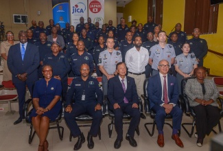 Permanent Secretary in the Ministry of National Security and Peace, Ambassador Alison Stone Roofe (seated left), along with (from second left, seated ) Head of the National Police College of Jamaica (NPCJ), Assistant Commissioner of Police (ACP) Merrick Watson; Ambassador of Japan to Jamaica, His Excellency, Yasuhiro Atsumi; Chargé d’Affaires, Brazilian Embassy in Jamaica, Antonio Otavio Sá Ricarte; and Chief Technical Director in the Ministry of Foreign Affairs and Foreign Trade, Ambassador Sharon Miller; pose with members of the Brazilian Military Police, and the 37 members of the Jamaica Constabulary Force (JCF) , who have completed training under  the Trilateral Cooperation Project: Jamaica Capacity Building on the Community Policing-KOBAN System. The closing out ceremony was held on September 19, at the NPCJ, in Twickenham Park, St. Catherine.