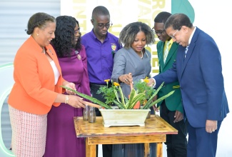 Minister of Education, Skills, Youth and Information, Dr. the Hon. Dana Morris Dixon (third right), participates in a planting ceremony during Shortwood Teachers' College’s 140th Anniversary Media Launch on Wednesday (September 10). The event was held at the College’s main campus in St. Andrew. Other participants (from left) are College Principal, Nadine Molloy; Cabinet Secretary, Hon. Audrey Sewell; students, Damalie Rowe and Tahj Alexander; and Chairman, Grantley Stephenson.