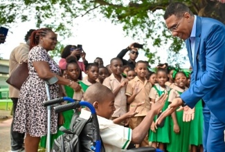 Prime Minister, the Most Hon Andrew Holness, greets Hope Valley Experimental School student, Ajani Cross, during a visit to the institution in September 2024 to mark the start of the 2024/25 academic year.
