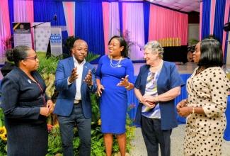 Minister of Labour and Social Security, Hon. Pearnel Charles Jr., engages in discussion with (from left) Managing Director, National Training and Programmes Division, HEART NSTA/Trust, Dr. Cheryl McLaughlin; Regional Director for HEART’s Region One, Dr. Sasha Shim-Hue; Executive Director, Mona Ageing and Wellness Centre, Professor the Most Hon. Denise Eldemire-Shearer; and Executive Director, National Council for Senior Citizens (NCSC), Cassandra Morrison. The occasion was the NCSC–HEART/NSTA Trust Digital Literacy Programme graduation ceremony at the Stony Hill HEART Academy in St. Andrew on Friday (September 26). The event formed part of the activities commemorating Senior Citizens Month 2025, being observed throughout September under the national theme: ‘Respect, Protect, Empower, Connect’.