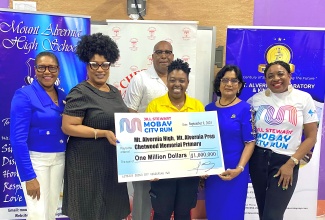 Principal of Mount Alvernia High, Kayon Whyne (second left), and Centennial Committee Chairman, Marline Stephenson Dalley (left), accept a symbolic $1-million cheque from the Jill Stewart MoBay City Run in support of centennial projects at Mount Alvernia High, Mount Alvernia Preparatory, and Chetwood Primary. Sharing in the occasion are Chair Administrator of the MoBay City Run, Asley Anguine (third left); Principal of Mount Alvernia Preparatory, Theresia Cheriann; and Chairman of the MoBay City Run, Janet Silvera. In the background is Principal of Chetwood Primary, Garvin Atkinson. The handover ceremony was held at Mount Alvernia High on September 9.

