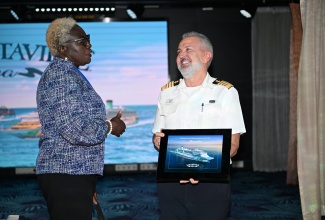 Administrator at the Port Authority of Jamaica, Shannon McCalla (fourth from left), joins Captain of the Margaritaville at Sea Islander, Theodore Mitropoulos (fifth from left), and Chief Executive Officer (CEO) of Lannaman & Morris Shipping Group, Charmaine Maragh (third from right), along with other stakeholders in a ceremonial exchange of plaques during the Margaritaville at Sea Islander inaugural call at Reynolds Pier in Ocho Rios, St. Ann, on Thursday, September 11.