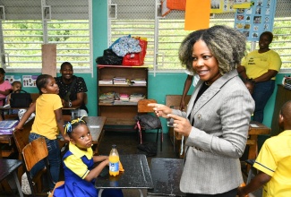 Minister of Education, Skills, Youth and Information, Senator Dr. the Hon. Dana Morris Dixon (right) engages students and their parents/guardians at the Constant Spring Primary and Infant School during orientation day activities. The institution was one of several visited by the Minister on day one (September 1) of the 2025/26 academic year.