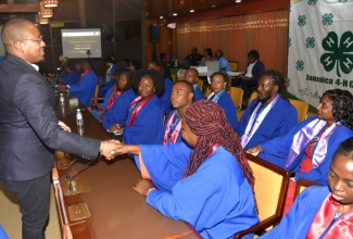 Minister of Agriculture, Fisheries and Mining, Hon. Floyd Green (left), engages with participants in the Rural Youth Economic Empowerment Programme (RYEEP) Builder, during the closing ceremony of the 2024/2025 cohort of the programme, on Friday (June 13), at the Jamaica Conference Centre in downtown Kingston.

