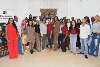 Senior Curator at the National Gallery of Jamaica (NGJ), Monique Barnett-Davidson (centre), and Acting Senior Director at NGJ, Nadine Boothe-Gooden (fifth right), join participating artists for a photo opportunity during the press launch of the One Nation, New Symbols exhibition, held at the Gallery in downtown Kingston on Monday (September 22).
