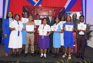First Heritage Co-operative (FHC) Credit Union Primary Exit Profile (PEP) awardees share a photo with Company Director Nickeisha Walsh (left); FHC Chief Executive Officer (CEO), Xavier Allen (second right), and guest speaker, Jeffrey Azan (sixth, right), during the FHC’s annual awards ceremony at The Jamaica Pegasus hotel in Kingston, on August 28.