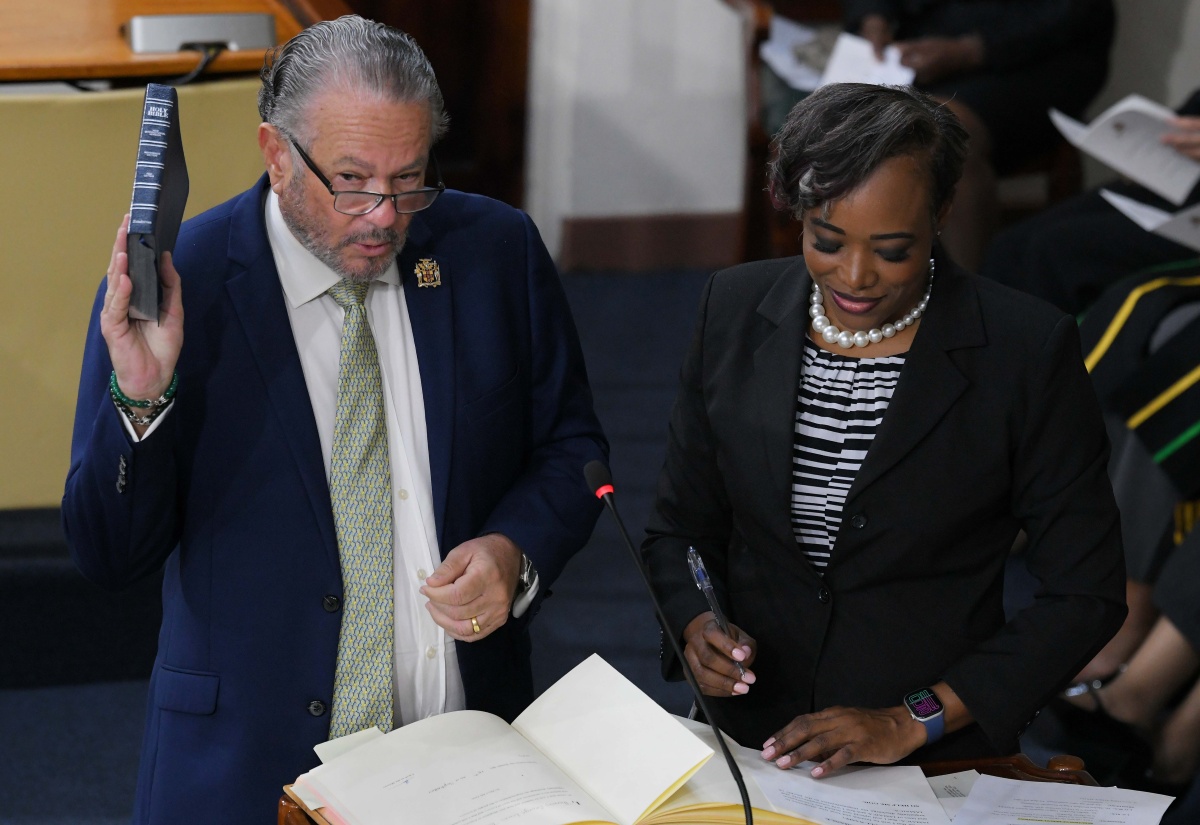 President of the Senate, Senator the Hon. Thomas Tavares-Finson, takes the Oath of Allegiance during the swearing-in of members of the Upper House at Gordon House on September 18. Observing the proceeding is Clerk to the Houses of Parliament, Colleen Lowe.


