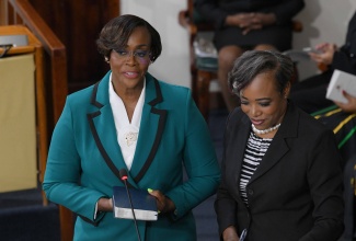 Speaker of the House of Representatives and Member of Parliament, St. Andrew East, the Most Hon. Juliet Holness, takes the Oath of Allegiance during the opening of the new Parliament and swearing-in of members of the Senate and the House of Representatives at Gordon House on September 18. Observing the proceeding is Clerk to the Houses of Parliament, Colleen Lowe.

