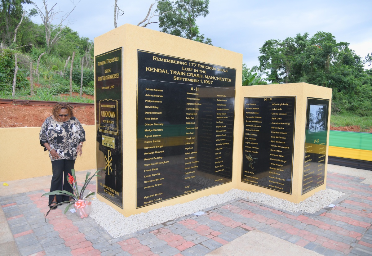 Minister of Culture, Gender, Entertainment and Sport, Hon. Olivia Grange, lays flowers at the site of the unveiled monument for the September 1, 1957 Kendal train crash victims, on September 11.

