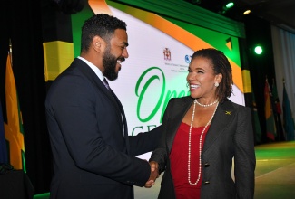 Minister without Portfolio in the Office of the Prime Minister with responsibility for Efficiency, Innovation and Digital Transformation, Ambassador Audrey Marks, is greeted by President, Caribbean Telecommunications Union and Minister of Public Administration and Artificial Intelligence, Trinidad and Tobago, Senator the Hon. Dominic Smith, at the opening ceremony for the Caribbean Telecommunications Union (CTU) Information and Communications Technology (ICT) Week 2025, at the AC Hotel in Kingston, on September 29.