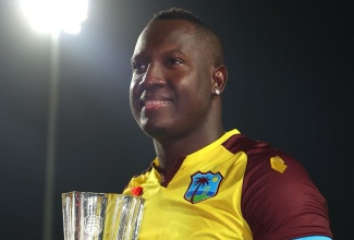 Jamaican and West Indies cricketer, Rovman Powell, displays the series trophy after winning the fifth and final T20I against England at the Brian Lara Cricket Stadium in Trinidad, in December 2023.